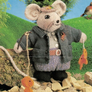 May include: A knitted mouse figurine named Little Tommy Tittlemouse, dressed in a gray jacket, blue pants, and a hat. The mouse is holding a fishing rod with an orange fish attached. The text "LITTLE TOMMY TITTLEMOUSE" is at the bottom.