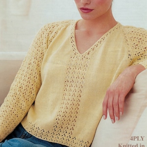 May include: A yellow knitted sweater with a V-neck and lace detailing. The sweater is made with 4-ply cotton yarn.