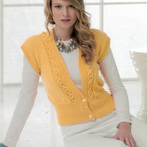 May include: A yellow knitted sleeveless vest with a cable knit pattern and button closure. The vest has a V-neck and is worn over a white shirt.