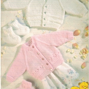 May include: Two knitted baby cardigans, one white and one pink, with matching booties. The cardigans have button closures and are made with a 4 ply yarn. The image includes the text "Tiny sizes for early arrivals" and "featured in FAIRYTALE 4 PLY".