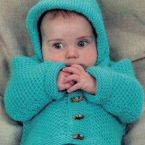 May include: A turquoise knitted baby cardigan with a hood and wooden buttons. The cardigan is made with a textured stitch pattern.