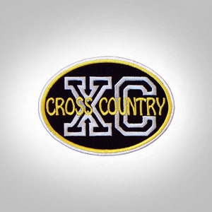 May include: Embroidered patch with the text "CROSS COUNTRY" in yellow and white, set against a black oval background. The patch has a white border with a yellow outline.