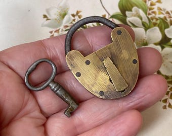 Fabulous antique miniature brass and iron padlock with a swivel keyhole cover and matching small key ( 1 )