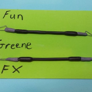 May include: Three black and gray sculpting tools on a green card with the words "Fun", "Greene", and "FX" written in black marker. The tools have gray tips and black handles.