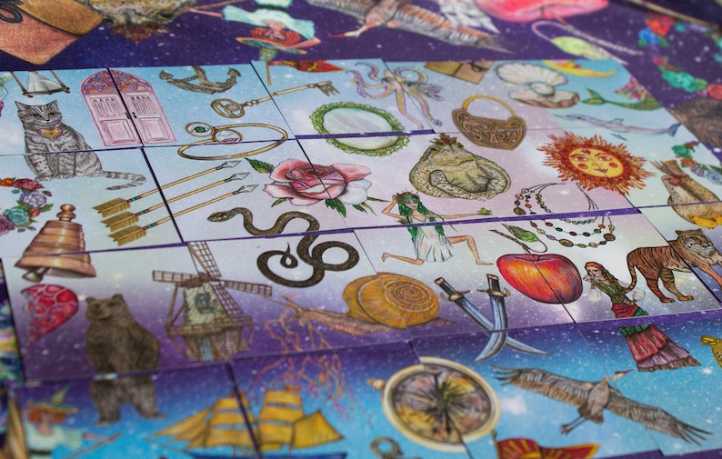 Close-up of several patience game cards showing hand-drawn mystical imagery on a cosmic background.