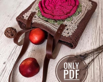 May include: A crocheted tote bag with a large pink rose on the front. The bag has brown leather straps and is sitting on a wooden surface. The text "ONLY PDF" is visible in a circle on the image.