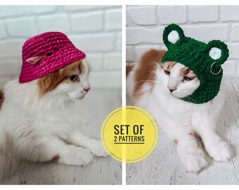 May include: Two crochet cat hats, one pink and one green. The pink hat is a bucket hat style and the green hat is a frog hat with white eyes. Both hats are on cats.