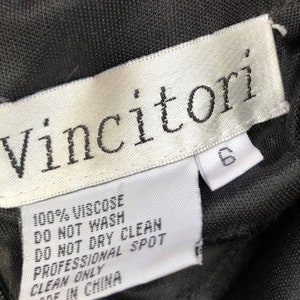 Puede incluir: Una etiqueta blanca con texto negro que dice "Vincitori" e instrucciones de cuidado para una prenda. La etiqueta dice "100% Viscosa", "No Lavar", "No Limpiar en Seco", "Limpieza en Seco Profesional", y "Hecho en China".