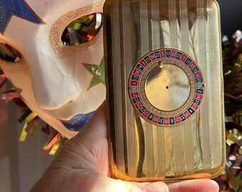 roulette cigarette holder Sold: brass made famous in “Mad Men”, ca. 1950's. This one has some patina and small dent to the body towards the bottom. The top spins but does not Vintage roulette wheel cigarette dispenser