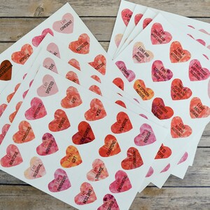 May include: A stack of white cards with watercolor hearts printed on them. Each heart has a positive affirmation printed on it, such as "I am confident", "I love my life", and "I am spirited".