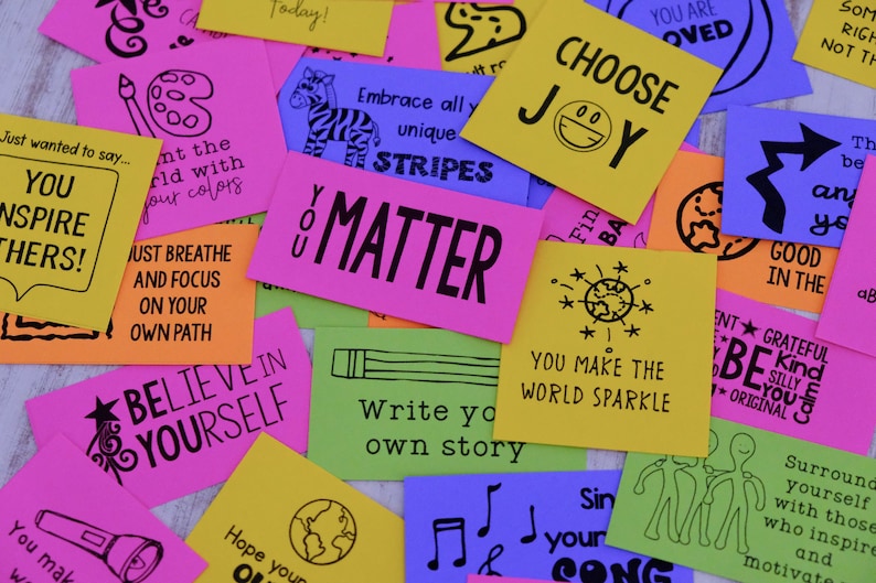 May include: A collection of colorful affirmation cards with positive messages like "You Matter", "Choose Joy", and "Believe in Yourself".