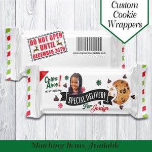 May include: White cookie wrapper with a red and green striped border. The wrapper has a photo of a young girl, the text "Chips Ahoy!" and "Special Delivery for Jordyn". The wrapper also has a red stamp that says "Do Not Open Until December 24th".