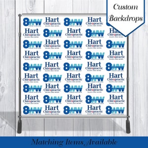 May include: A blue and white backdrop with the text "Hart Chiropractic" and the logo "8 Weeks to Wellness" repeated across the surface. The backdrop is designed for use as a photography background.