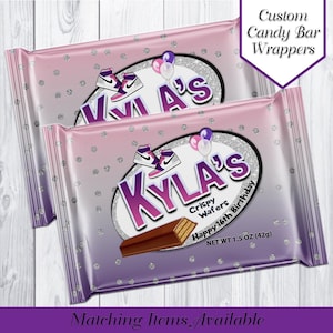 May include: Two pink and silver candy bar wrappers with a silver glitter background. The wrappers feature a white oval with the text "KYLA'S" in purple letters, a purple and white sneaker graphic, and the text "Crispy Wafers Happy 16th Birthday NET WT 1.5 OZ (42g)".