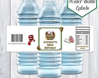 May include: Three clear plastic water bottles with labels. The labels are white with a green and gold border. The label has a casino theme with playing cards, dice, and the text "Casino Night Anthony's 32nd Birthday".