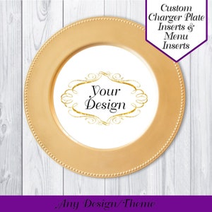 May include: Gold charger plate with a white insert featuring a gold ornate frame with the text "Your Design".