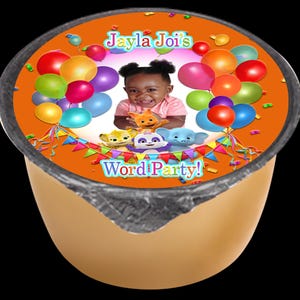 May include: Orange and yellow container with a colorful label featuring a child's photo, balloons, and the text "Jayla Joi's Word Party!"