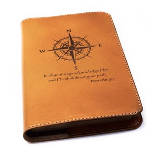 May include: A brown leather journal with a compass and the Bible verse "In all your ways acknowledge Him, and He shall direct your path. Proverbs 3:5" engraved on the front cover.