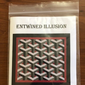 May include: A quilting pattern for a geometric quilt called "Entwined Illusion". The quilt is 28 inches by 29 inches and features a black, white, and gray pattern with a red border. The pattern is available from Cathy's Quilts N Embroidery.