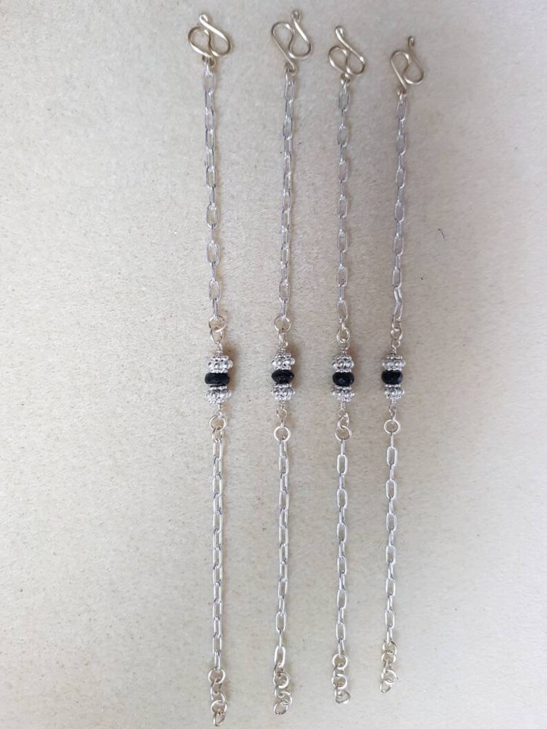 Black faceted spinel silver chain bracelet with 925 sterling silver spacer beads.