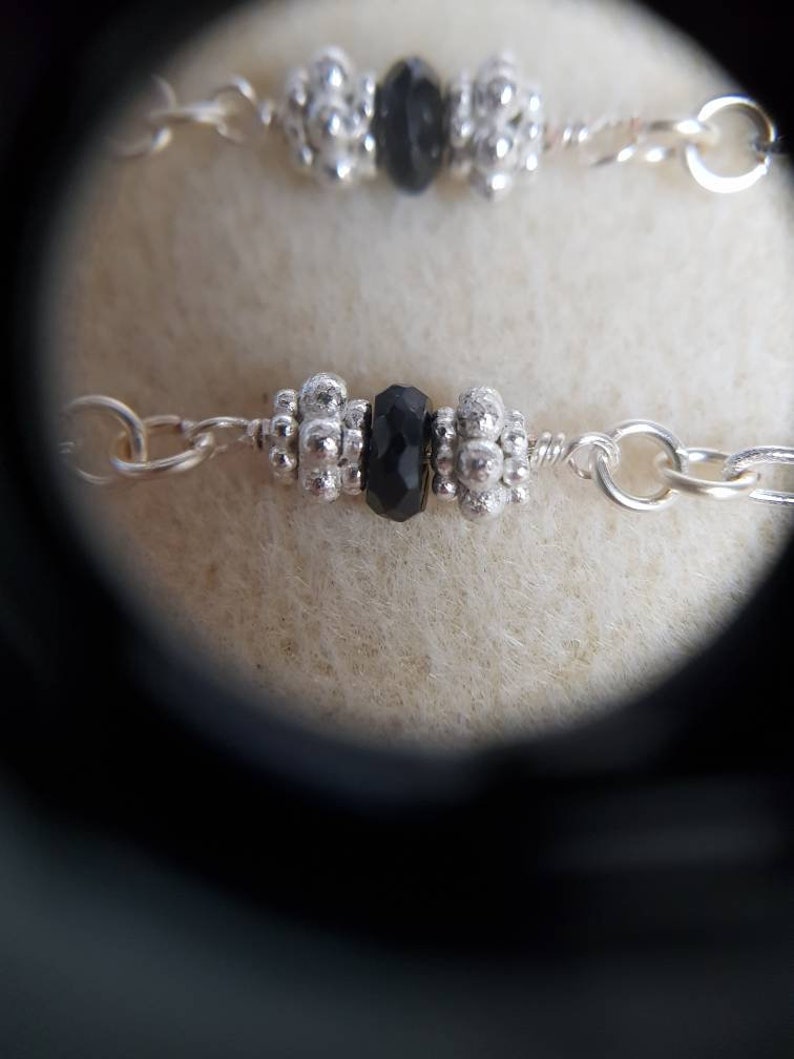 Black faceted spinel silver chain bracelet with 925 sterling silver spacer beads.