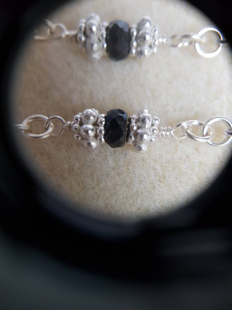 Black faceted spinel silver chain bracelet with 925 sterling silver spacer beads.