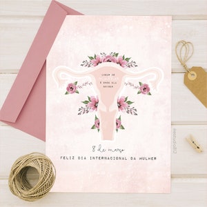 May include: A pink and white card with a stylized illustration of a uterus with flowers. The text on the card reads "Lugar de mulher &eacute; onde ela quiser" and "8 de mar&ccedil;o Feliz Dia Internacional da Mulher".