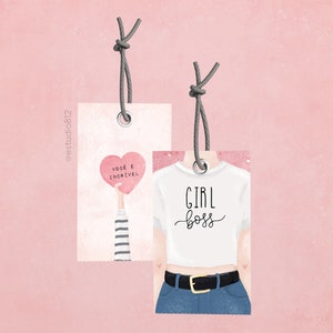 May include: Two gift tags with string attached. The tag on the left has a pink heart with the text "voce e incrivel" in black. The tag on the right has a white t-shirt with the text "GIRL boss" in black.