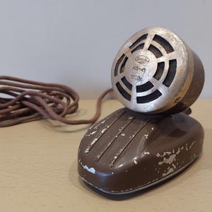 May include: A set of three ceramic mugs with a speckled, matte finish. Each mug features a different color: light blue, cream, and gray. The mugs have a simple, modern design with a rounded shape and a comfortable handle.