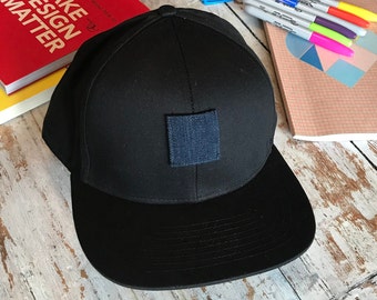 Minimalistic black hat designed in Amsterdam, only 49 units made, marked with production number, assembled by hand