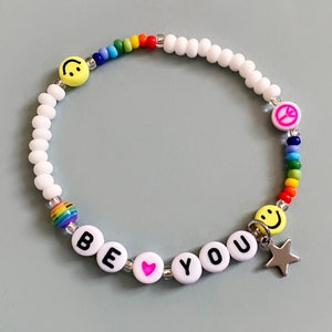 Rainbow Bracelet with star charm. Be You. Can be personalised with any name or word. Rainbow, smiley and peace sign beads. White.