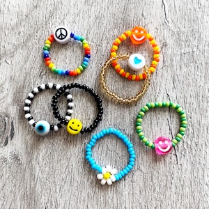 Dainty Beaded rings. Choose your seed bead colours. Smiley, eyeball, heart and daisy flower. Rainbow colours. Gold and Silver.