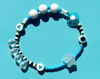 Sensory fidget bracelet. Sliding glow in the dark star, rolling bead, rubber, glass, evil eye. Turquoise.