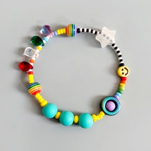 Sensory fidget bracelet. Rainbow, sliding glow in the dark star, hematite smiley spinner, rubber and glass beads. Adult or child size.