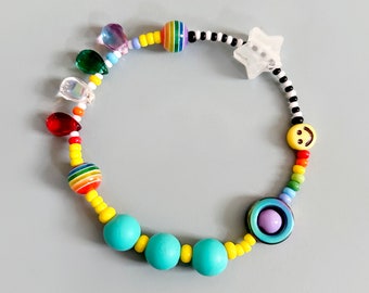 Sensory fidget bracelet. Rainbow, sliding glow in the dark star, hematite smiley spinner, rubber and glass beads. Adult or child size.