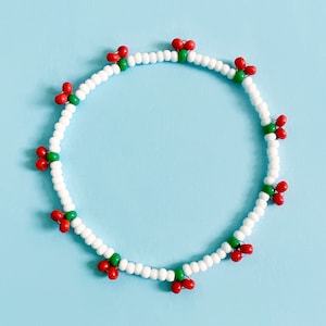 Handmade beaded cherry bracelet. White with juicy red cherries. Elasticated. Glass beads.
