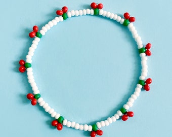 Handmade beaded cherry bracelet. White with juicy red cherries. Elasticated. Glass beads.