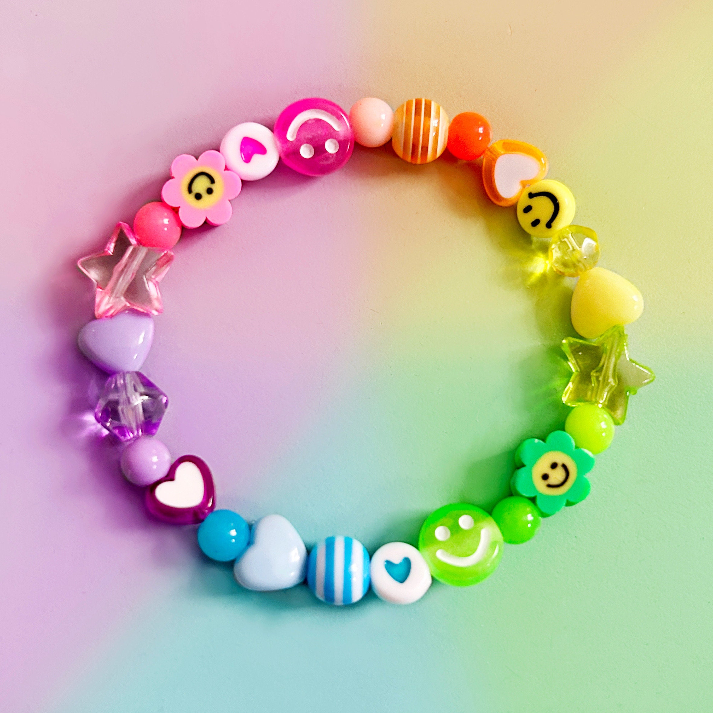 Mixed bead party bracelet. Handmade. Elasticated. Rainbow colours. Smileys,  flowers, hearts and stars. Super cute and colourful.