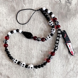 Halloween phone charm. Gothic. Horror. Black and White with blood red feature beads and skulls.