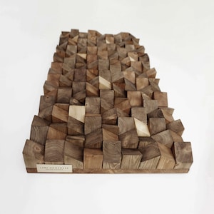May include: A brown wooden wall panel made of small, irregular blocks. The panel has a textured surface and a modern design. The panel is labelled "LIBRA HOMEWARE" in the bottom right corner.