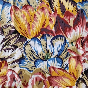 May include: A fabric pattern featuring a dense arrangement of tulips in vibrant shades of yellow, deep red, and blue. The petals display intricate, streaked color variations with white highlights, creating a layered, botanical floral design.