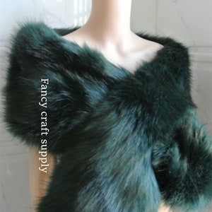 May include: A dark green faux fur shawl. The shawl is draped over a white mannequin. The text "Fancy craft supply" is visible on the shawl.