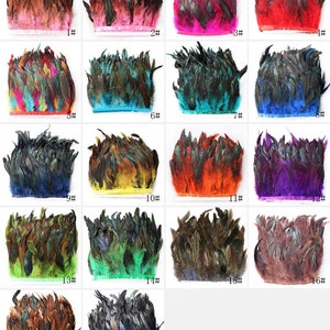 May include: Assortment of 18 feather trims in various colors, including red, pink, blue, green, yellow, orange, purple, and brown. Each trim is approximately 1 inch wide and features a variety of feather lengths.