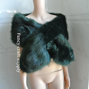 May include: A dark green faux fur shawl. The shawl is draped over a mannequin. The text "Fancy craft supply" is visible on the left side of the image.