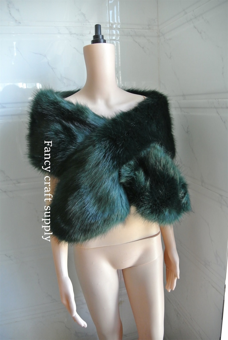 May include: A dark green faux fur shawl. The shawl is draped over a mannequin. The text "Fancy craft supply" is visible on the left side of the image.