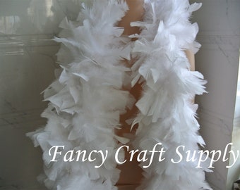 May include: A white feather boa, a long, fluffy strip of feathers, ideal for adding a touch of elegance to costumes, crafts, or home decor. The boa is shown draped over a mannequin. The text "Fancy Craft Supply" is visible at the bottom of the image.