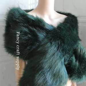 May include: A dark green faux fur shawl. The shawl is draped over a mannequin's shoulders. The text "Fancy craft supply" is visible on the shawl.