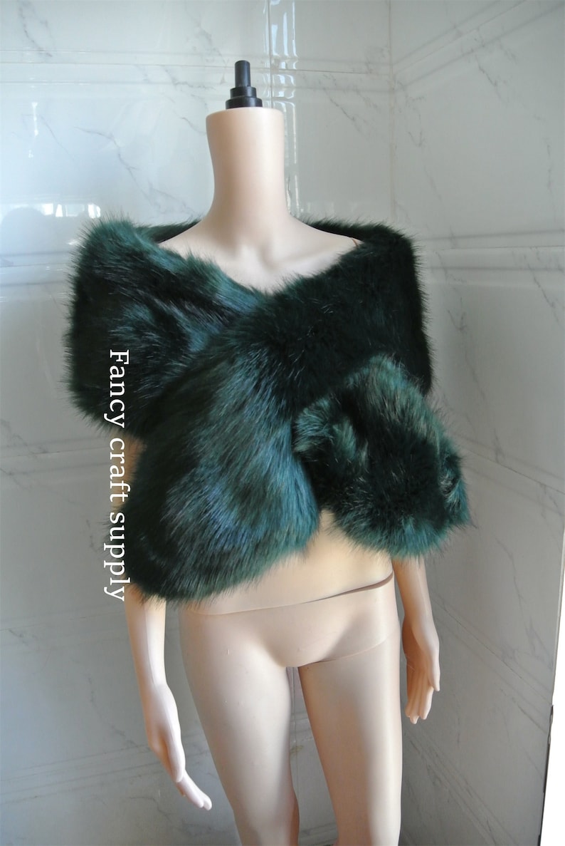 May include: A dark green faux fur shawl. The shawl is draped over a mannequin's shoulders. The text "Fancy craft supply" is visible on the left side of the image.