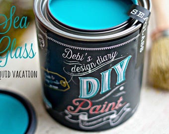 May include: A can of turquoise blue paint labeled "Sea Glass Liquid Vacation" with the text "Debi's design diary DIY Paint" on the side.