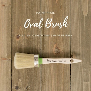 May include: A natural bristle oval brush with a green handle. The brush is labeled "Paint Pixie" and "Made in Italy 12". The brush is 1 3/4 inches wide and is labeled as an oval/round brush.